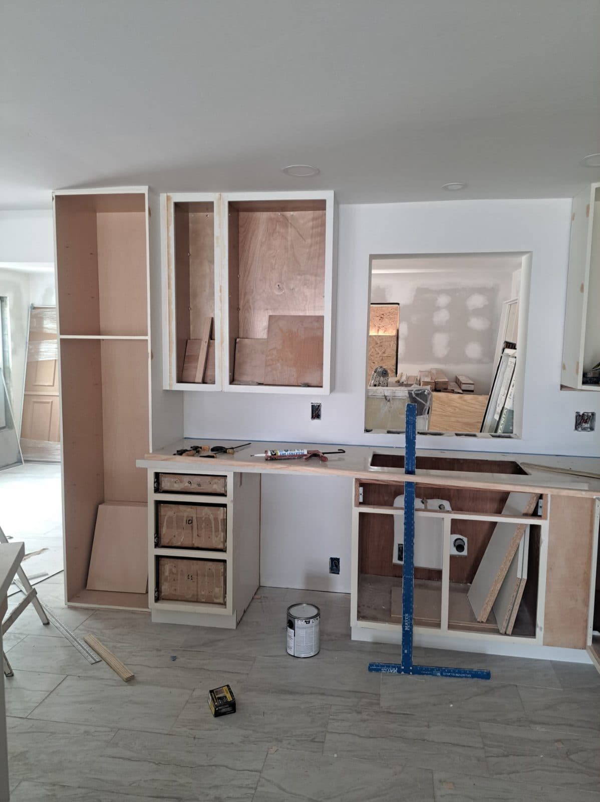 Cabinets going in, leveled with a laser